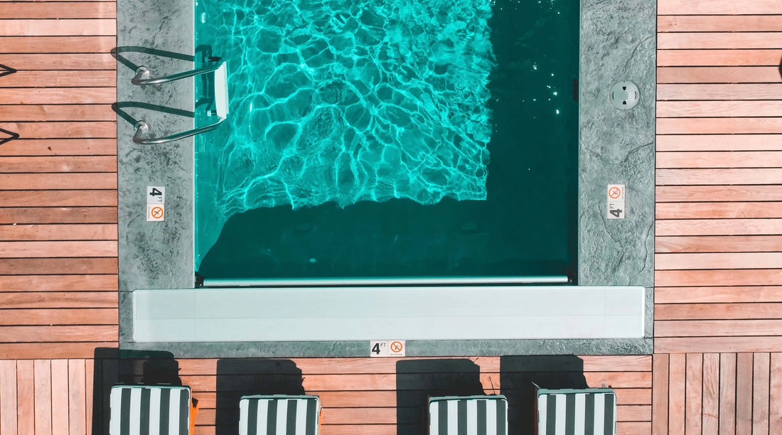 Swimming that is using a pool weir cover on the right side of the pool